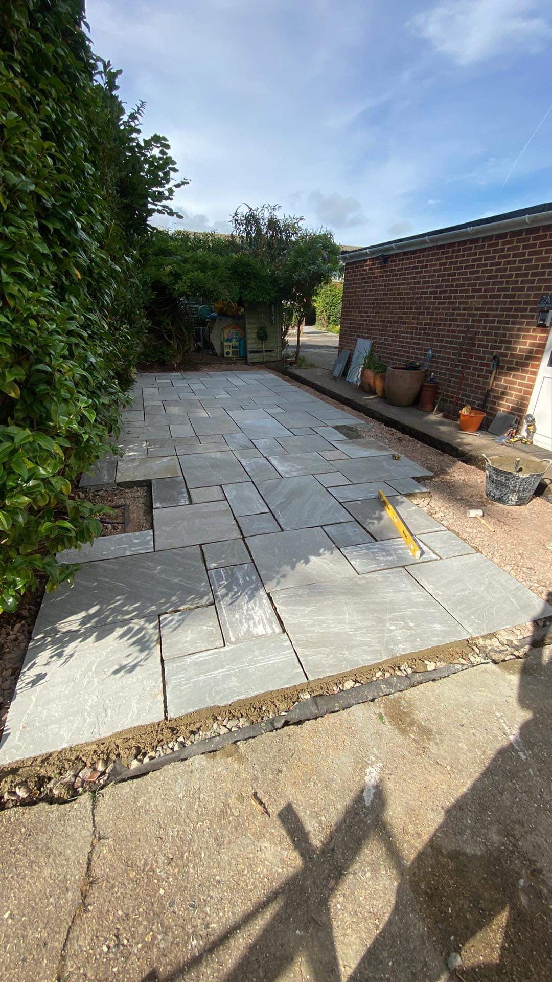 Patio slabs being laid and levelled during a garden redesign in Chandlers Ford
